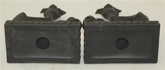 A pair of Wedgwood black basalt dolphin candlesticks, 21.5cm